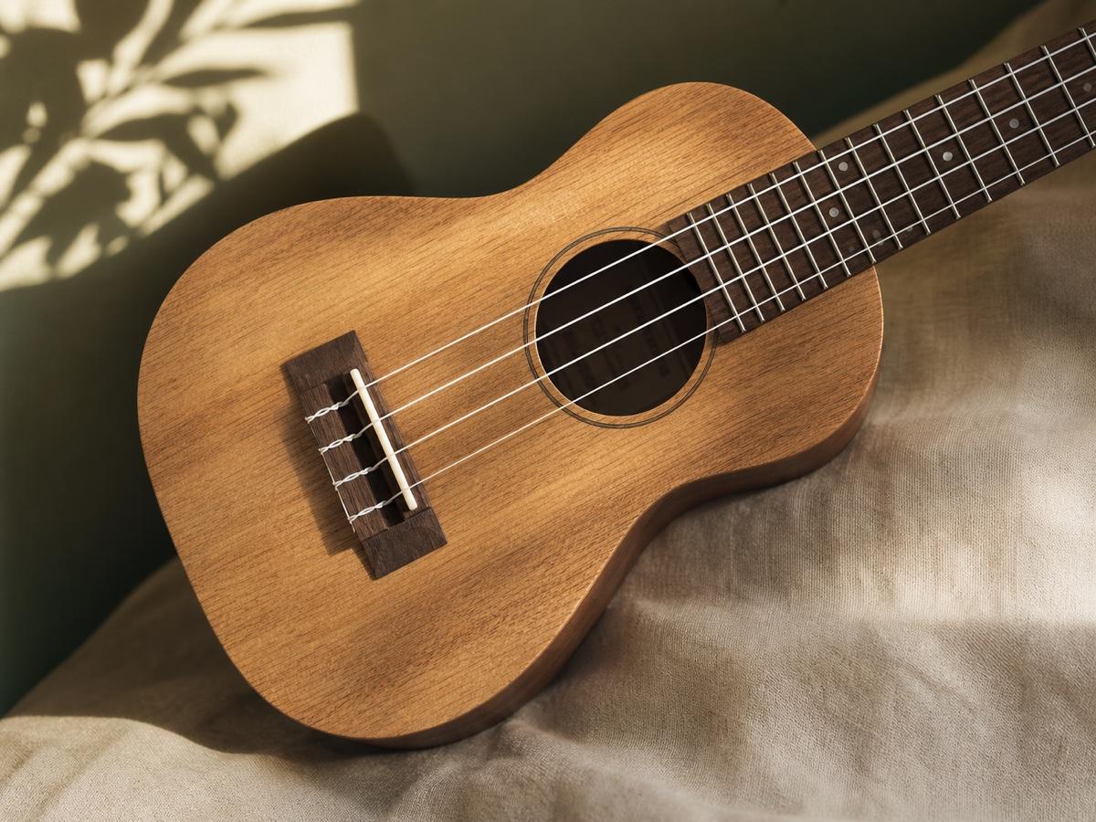 A softly lit wooden ukulele with four strings